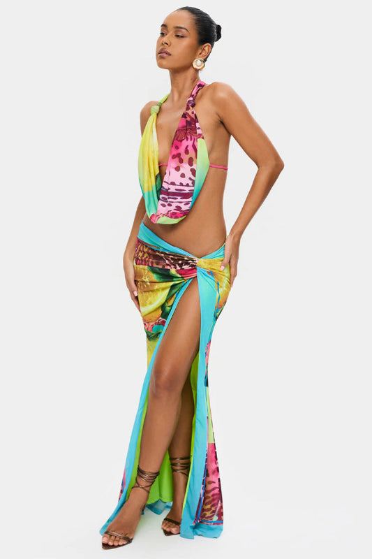 Woman wearing a colorful dress with a slit on a white background